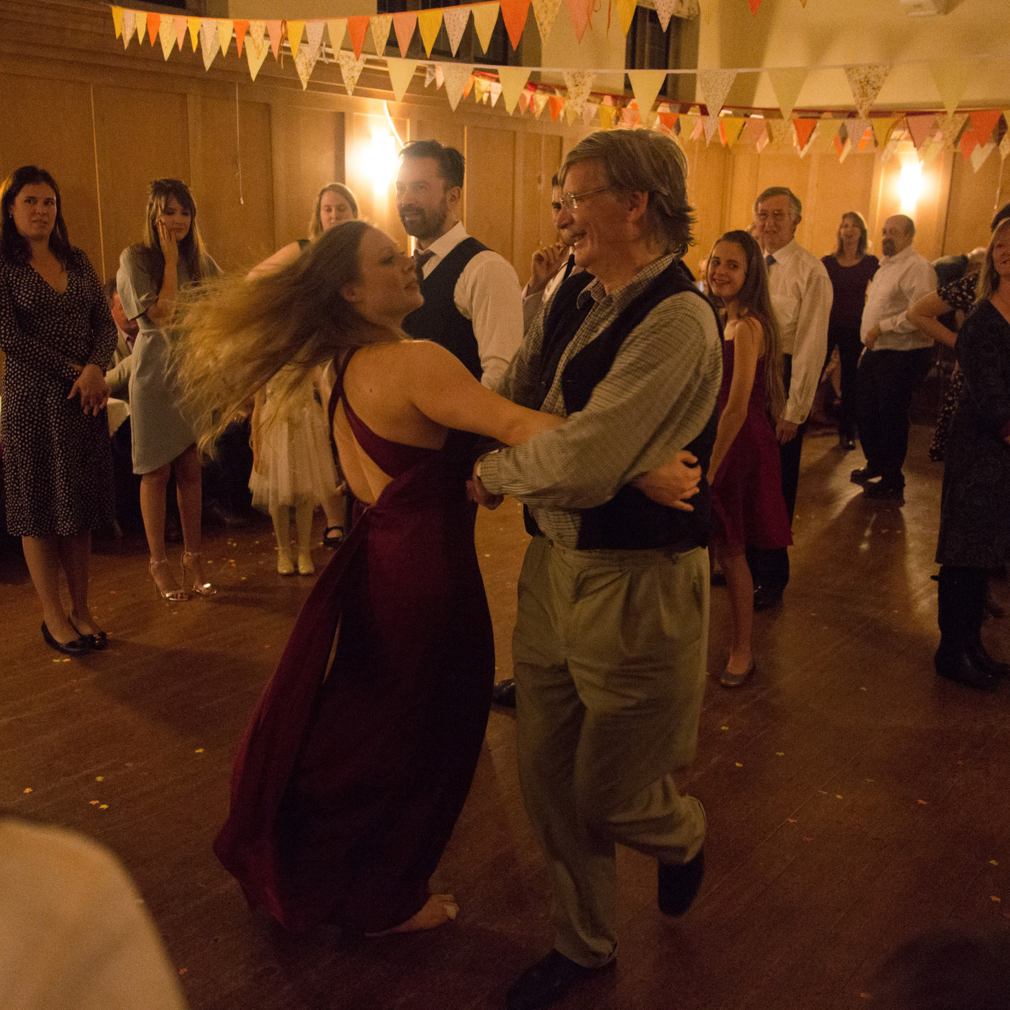 Photo of our caller demonstrating a swing with a dancer.